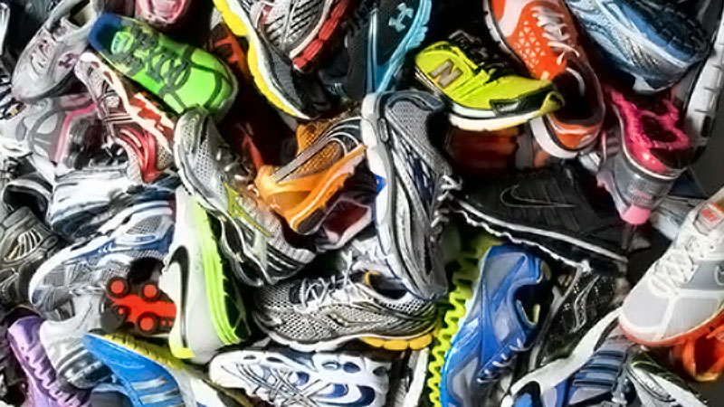 Pile of used sneakers in different colors