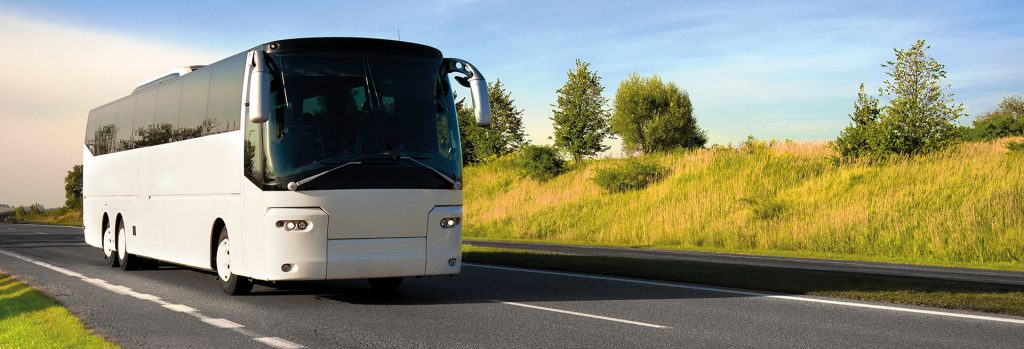 Photo of a tour bus on a two lane highway.